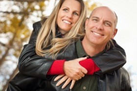 9357729-happy-attractive-couple-in-park-with-leather-jackets