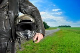 leather-motorcycle-biker-with-helmet-closeup-on-a-road